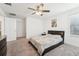 Carpeted bedroom features ceiling fan, painting, and comfortable bed and bedding at 1741 Cherry Walk Rd, Lutz, FL 33558