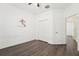 Bright bedroom features wood-look flooring, a ceiling fan, and a closet at 1741 Cherry Walk Rd, Lutz, FL 33558