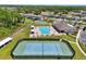 An aerial view showcases the tennis court, pool, and other community recreational amenities at 1741 Cherry Walk Rd, Lutz, FL 33558