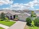 Charming home featuring manicured landscaping, a paver driveway, and a welcoming front porch at 1741 Cherry Walk Rd, Lutz, FL 33558