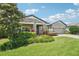 Charming exterior view with stone accents, lush landscaping, and well-maintained front yard at 1741 Cherry Walk Rd, Lutz, FL 33558