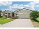 Attractive exterior with brick driveway, lush green lawn, and well-manicured landscaping at 1741 Cherry Walk Rd, Lutz, FL 33558