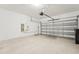 Clean and spacious garage with an electric vehicle charger and garage door at 1741 Cherry Walk Rd, Lutz, FL 33558