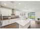 Kitchen with large island, stainless appliances, stone counters and a sliding glass door to the yard at 1741 Cherry Walk Rd, Lutz, FL 33558
