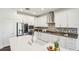 Contemporary kitchen featuring stainless steel appliances, a large island, and sleek white cabinets at 1741 Cherry Walk Rd, Lutz, FL 33558