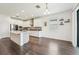 Open kitchen with white cabinets, stainless appliances, an island, and stylish backsplash at 1741 Cherry Walk Rd, Lutz, FL 33558