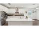 Modern kitchen with a large island, white cabinets, and stainless steel appliances at 1741 Cherry Walk Rd, Lutz, FL 33558