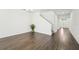 Spacious living room boasts modern hardwood floors and an open floor plan, with staircase access at 1741 Cherry Walk Rd, Lutz, FL 33558