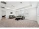 Spacious living room with tray ceiling, large windows and comfortable seating area at 1741 Cherry Walk Rd, Lutz, FL 33558