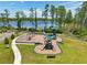 A modern playground offers slides and swings with views of a picturesque lake at 1741 Cherry Walk Rd, Lutz, FL 33558