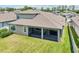 An inviting home exterior features a screened patio and a well-maintained lawn at 1741 Cherry Walk Rd, Lutz, FL 33558