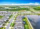 Aerial view showcases the community's layout with homes, lakes, and landscaped roadways at 17683 Ramble On Way, Land O Lakes, FL 34638