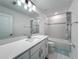 Bathroom showcasing a tub and shower combo with modern fixtures and finishes at 17683 Ramble On Way, Land O Lakes, FL 34638