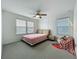 This bedroom has a unique style with a nice carpet, many windows, and ceiling fan at 17683 Ramble On Way, Land O Lakes, FL 34638