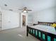 This bedroom features a walk-in closet, carpeted floors, and a ceiling fan at 17683 Ramble On Way, Land O Lakes, FL 34638