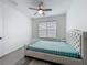 Well-lit bedroom with stylish wood-look flooring, a ceiling fan, and window at 17683 Ramble On Way, Land O Lakes, FL 34638