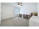 Bright bedroom featuring a ceiling fan, a study desk, and a bookshelf at 17683 Ramble On Way, Land O Lakes, FL 34638