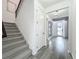Bright entryway boasts hardwood floors, staircase, and front door with sidelights and transom window at 17683 Ramble On Way, Land O Lakes, FL 34638