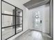 Bright entryway with stylish decor, mirror accents, and wood-look tile flooring at 17683 Ramble On Way, Land O Lakes, FL 34638