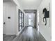 Long foyer with luxury vinyl floors, decorative mirrors, and unique design at 17683 Ramble On Way, Land O Lakes, FL 34638