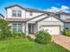 Charming two-story home with well-maintained landscaping and a brick paver driveway at 17683 Ramble On Way, Land O Lakes, FL 34638