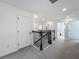 Spacious upstairs hallway with plush carpeting, white trim, and multiple bedroom entrances at 17683 Ramble On Way, Land O Lakes, FL 34638