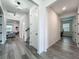 Open hallway showcasing wood-look floors, modern lighting, and views into adjacent living spaces at 17683 Ramble On Way, Land O Lakes, FL 34638