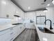 Modern kitchen with white cabinets, subway tile backsplash, and stainless steel appliances at 17683 Ramble On Way, Land O Lakes, FL 34638
