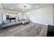 Comfortable living room showcasing the open layout, contemporary lighting, and modern design at 17683 Ramble On Way, Land O Lakes, FL 34638