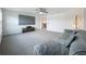Spacious living room featuring carpet, ceiling fan, large sectional, and a mounted flatscreen TV at 17683 Ramble On Way, Land O Lakes, FL 34638