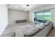 Stylish living room featuring modern lighting, a designer wall, and sliding glass doors overlooking a lake at 17683 Ramble On Way, Land O Lakes, FL 34638