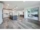 Open concept living space featuring the kitchen, living room, and access to the screened patio at 17683 Ramble On Way, Land O Lakes, FL 34638
