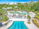 Resort-style pool area featuring a lap pool, lounge chairs, and lush landscaping at 17683 Ramble On Way, Land O Lakes, FL 34638