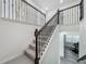 Staircase with decorative wrought iron balusters and wood handrail leads to the upper level at 17683 Ramble On Way, Land O Lakes, FL 34638
