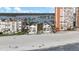Aerial view showcasing beachfront condos with ocean views, nestled along the sandy coastline and a scenic bay at 17960 Gulf Blvd # 225, Redington Shores, FL 33708