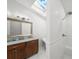 Well-lit bathroom showcasing a shower, vanity, and modern fixtures under a skylight at 17960 Gulf Blvd # 225, Redington Shores, FL 33708