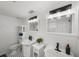 Bright white bathroom with dual vanities offers ample space and classic style at 17960 Gulf Blvd # 225, Redington Shores, FL 33708