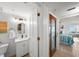 Well-lit bathroom features a modern vanity and a view into the bedroom at 17960 Gulf Blvd # 225, Redington Shores, FL 33708