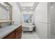 Bright bathroom featuring a clawfoot tub, white subway tiles, and a window with a view at 17960 Gulf Blvd # 225, Redington Shores, FL 33708