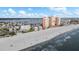 Aerial view of a sunny white sand beach, the Gulf of Mexico, condos and the intercoastal waterway at 17960 Gulf Blvd # 225, Redington Shores, FL 33708