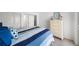 Bright bedroom with blue striped quilt and white dresser offers a comfortable retreat at 17960 Gulf Blvd # 225, Redington Shores, FL 33708