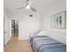 This bedroom is complete with tile floors, closet, and spiral staircase access at 17960 Gulf Blvd # 225, Redington Shores, FL 33708