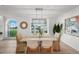 Inviting dining room with modern lighting and picturesque backyard view at 17960 Gulf Blvd # 225, Redington Shores, FL 33708