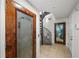 Hallway featuring a decorative door, tile floors, a spiral staircase, and an additional door at 17960 Gulf Blvd # 225, Redington Shores, FL 33708
