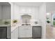 This kitchenette features white cabinetry, stone countertops and stainless steel appliances at 17960 Gulf Blvd # 225, Redington Shores, FL 33708