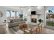 Cozy living room with white brick fireplace, ceiling fan, comfortable seating, and ocean view windows at 17960 Gulf Blvd # 225, Redington Shores, FL 33708