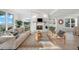 Bright living room featuring a fireplace, comfortable sofa, and views of the community at 17960 Gulf Blvd # 225, Redington Shores, FL 33708