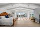 Bright main bedroom with vaulted ceilings, access to a balcony with ocean views, and stylish decor at 17960 Gulf Blvd # 225, Redington Shores, FL 33708