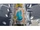 Aerial view of a kidney-shaped pool surrounded by lounge chairs in a condo community with white roofs at 17960 Gulf Blvd # 225, Redington Shores, FL 33708