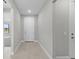 Bright entryway with tiled flooring, neutral walls, and a view into the spacious living areas at 1925 Pepper Grass Dr, North Port, FL 34289